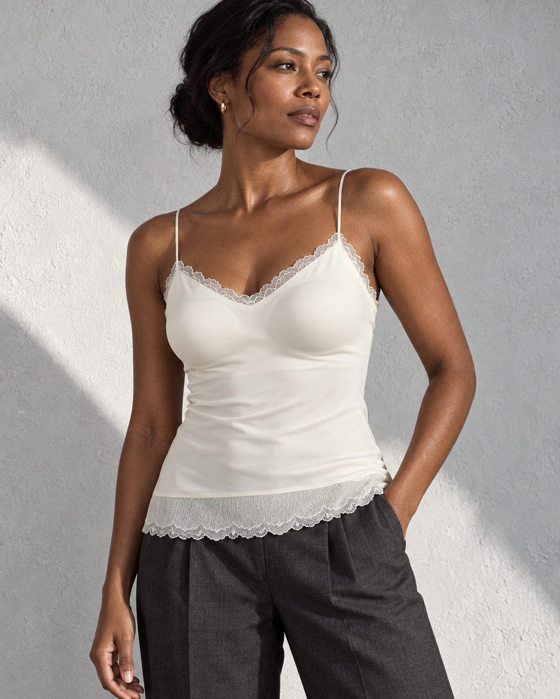 Adult woman wearing the ivory lace-trim low-back camisole